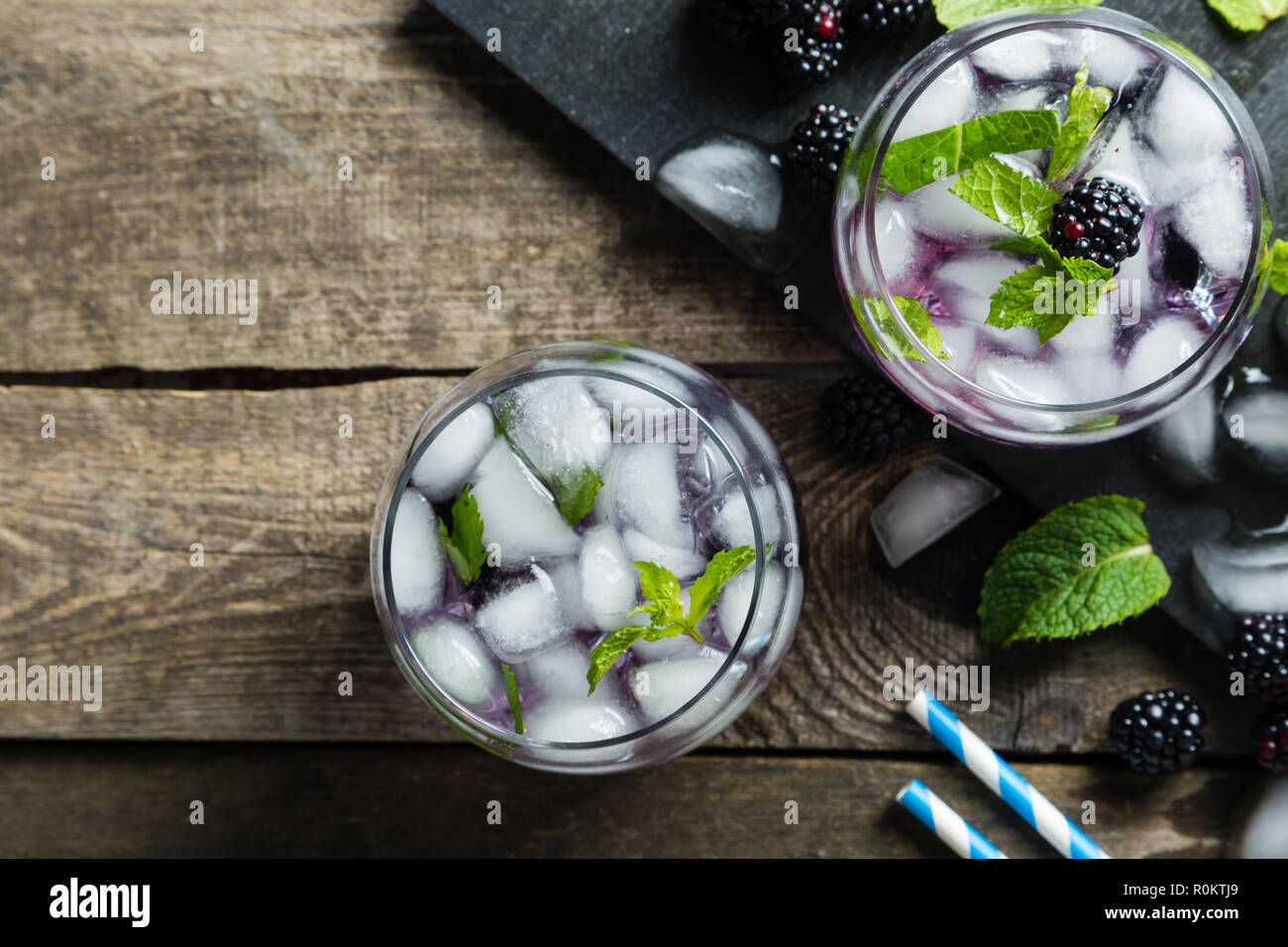 Blackberry mojito and ingredients on rustic background Stock Photo