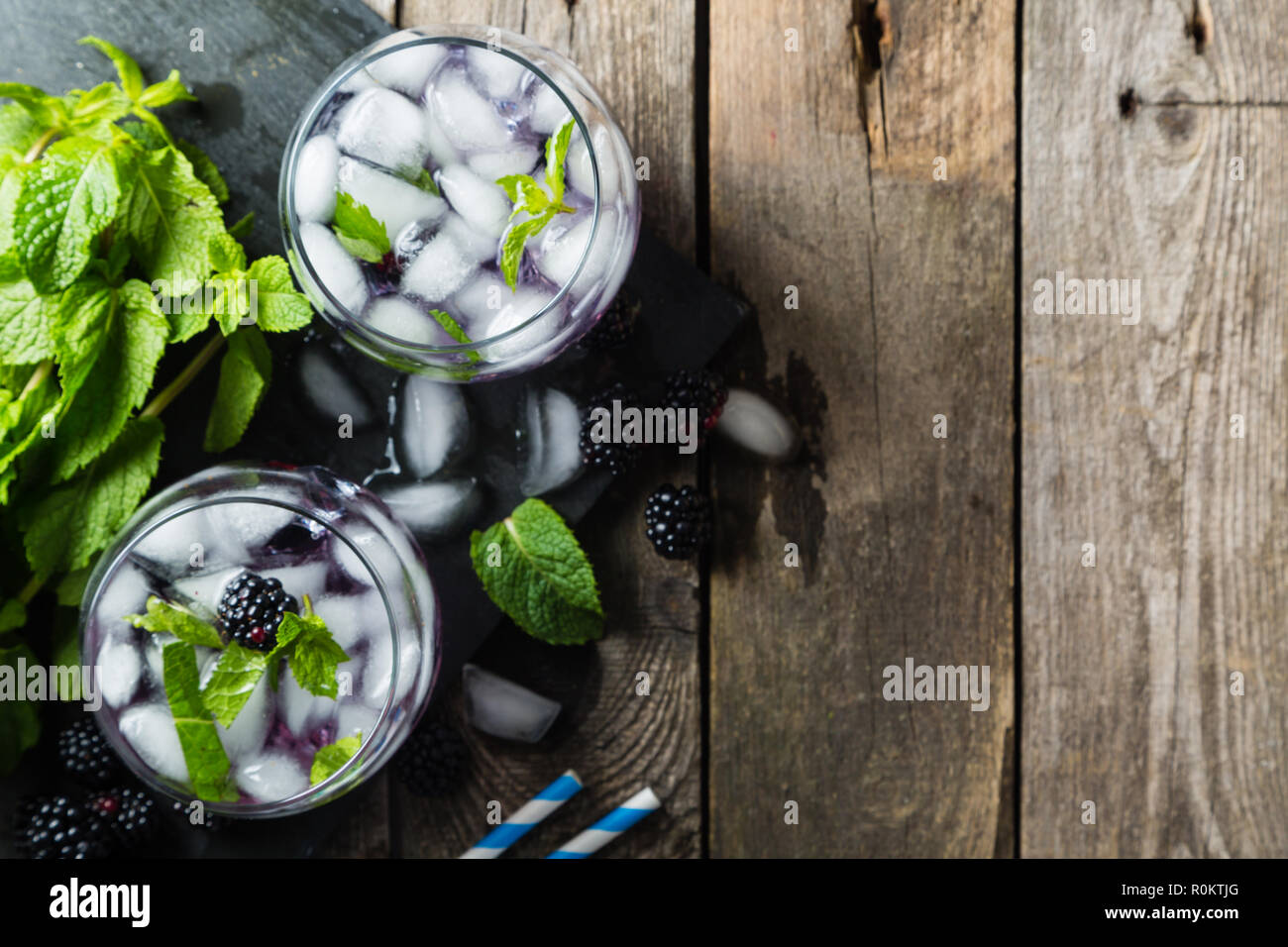 Blackberry mojito and ingredients on rustic background Stock Photo
