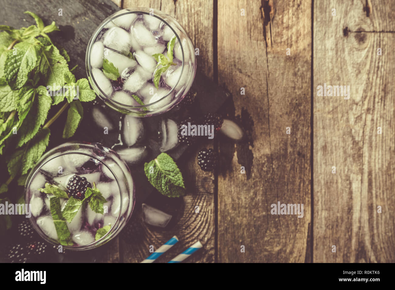 Blackberry mojito and ingredients on rustic background Stock Photo