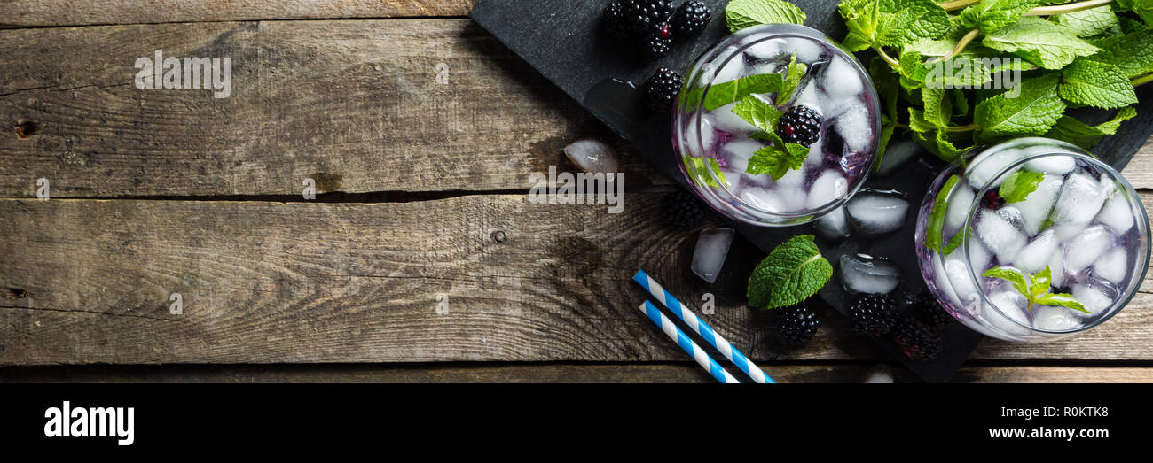 Blackberry mojito and ingredients on rustic background Stock Photo