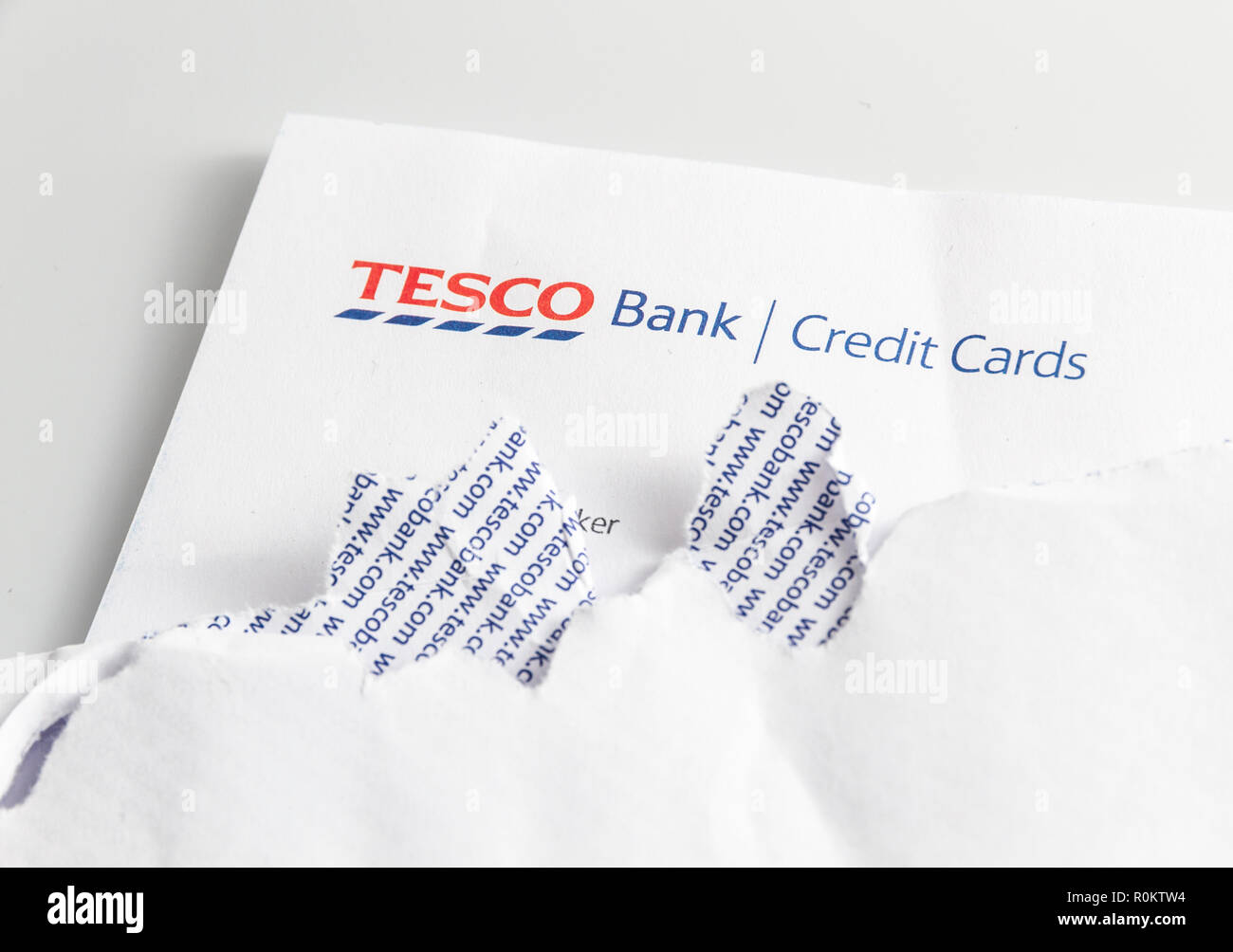 Tesco Bank Credit Card statement on table with ripped open envelope. Stock Photo