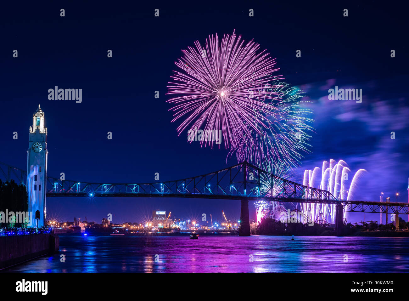 Fireworks display over a city bridge Stock Photo