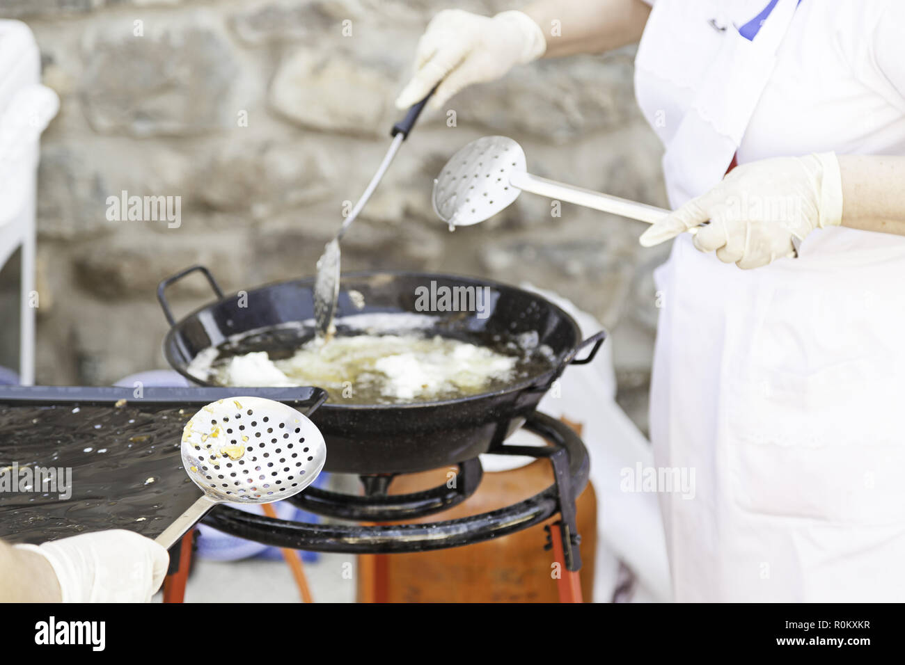Fry eggs, detail of a women on the street cooking eggs, hot oil Stock Photo
