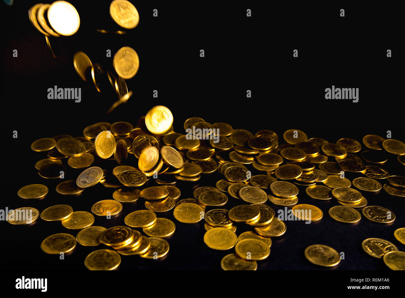 Falling gold coins money in dark background, business concept idea Stock  Photo - Alamy