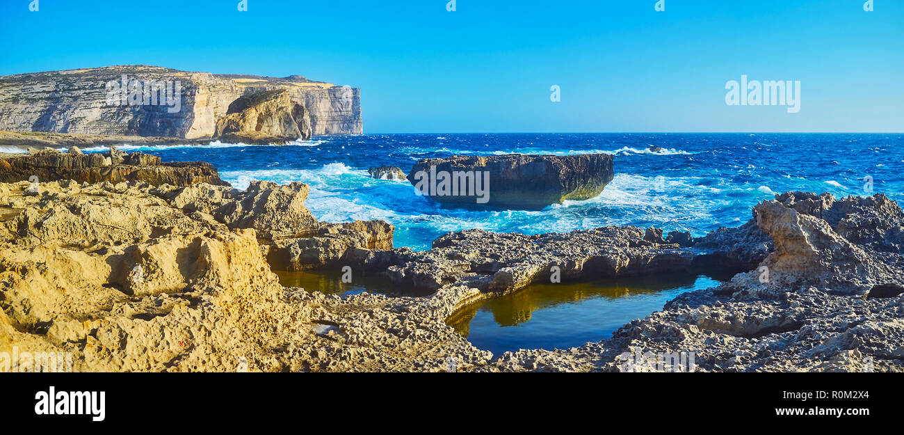 Indented rocky coast of San Lawrenz is the best place for the walks, enjoying the nature, landscape of Gozo Island and Mediterranean stormy waves, Mal Stock Photo