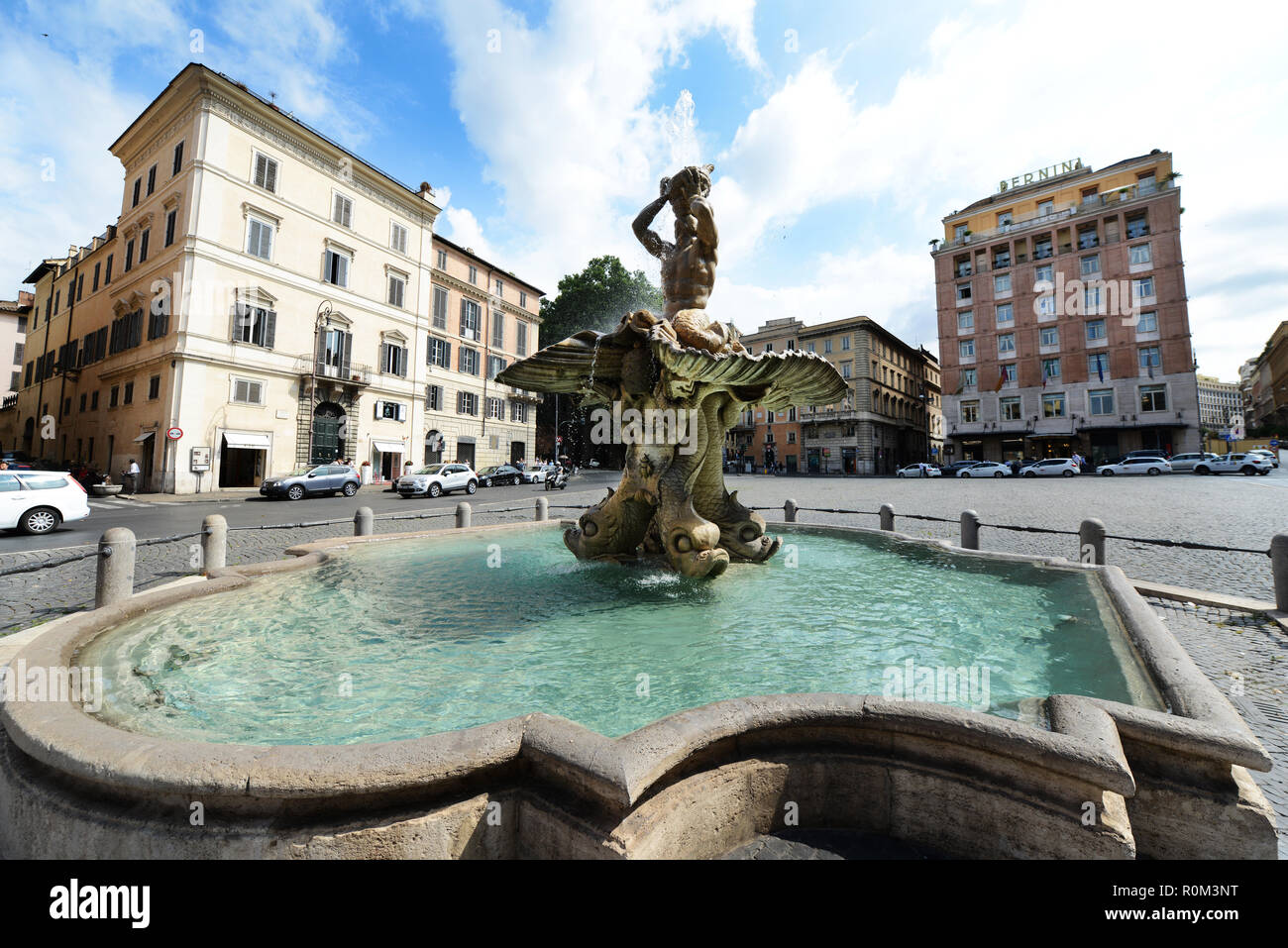 Fontana del Tritone - 17th-century baroque fountain in a public square, featuring a sea god surrounded by dolphins. Stock Photo