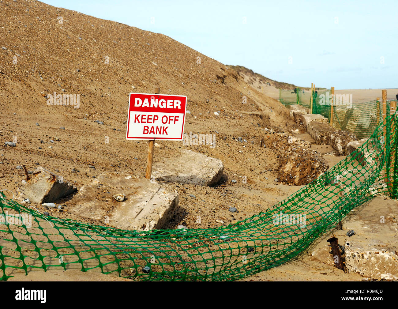 An attempt to protect the face of a sand dune from further marine erosion by regrading of the slope and provision of basic rock armour, Winterton, Nfk. Stock Photo