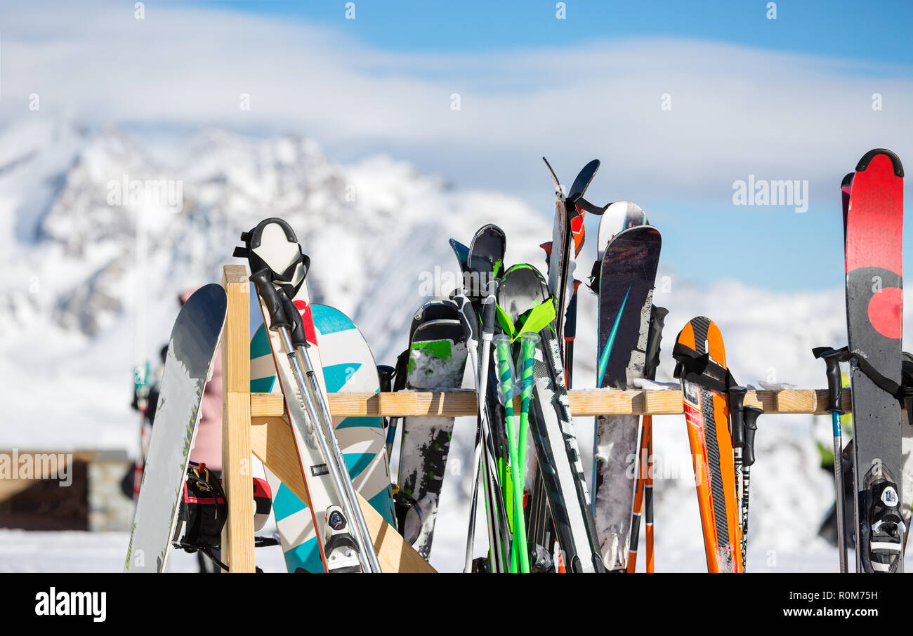 Photo of multi-colored skis in snow at winter resort in afternoon. Stock Photo