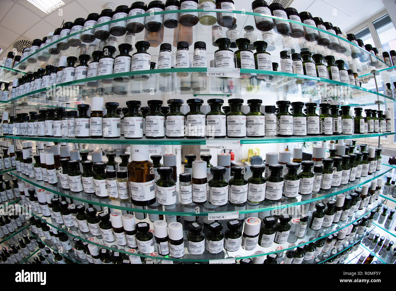 Holzminden, Germany. 23rd Oct, 2018. Various aromas in bottles from Symrise AG are on a shelf. Symrise AG is one of the world's leading suppliers of fragrances and flavors. Credit: Swen Pförtner/dpa/Alamy Live News Stock Photo