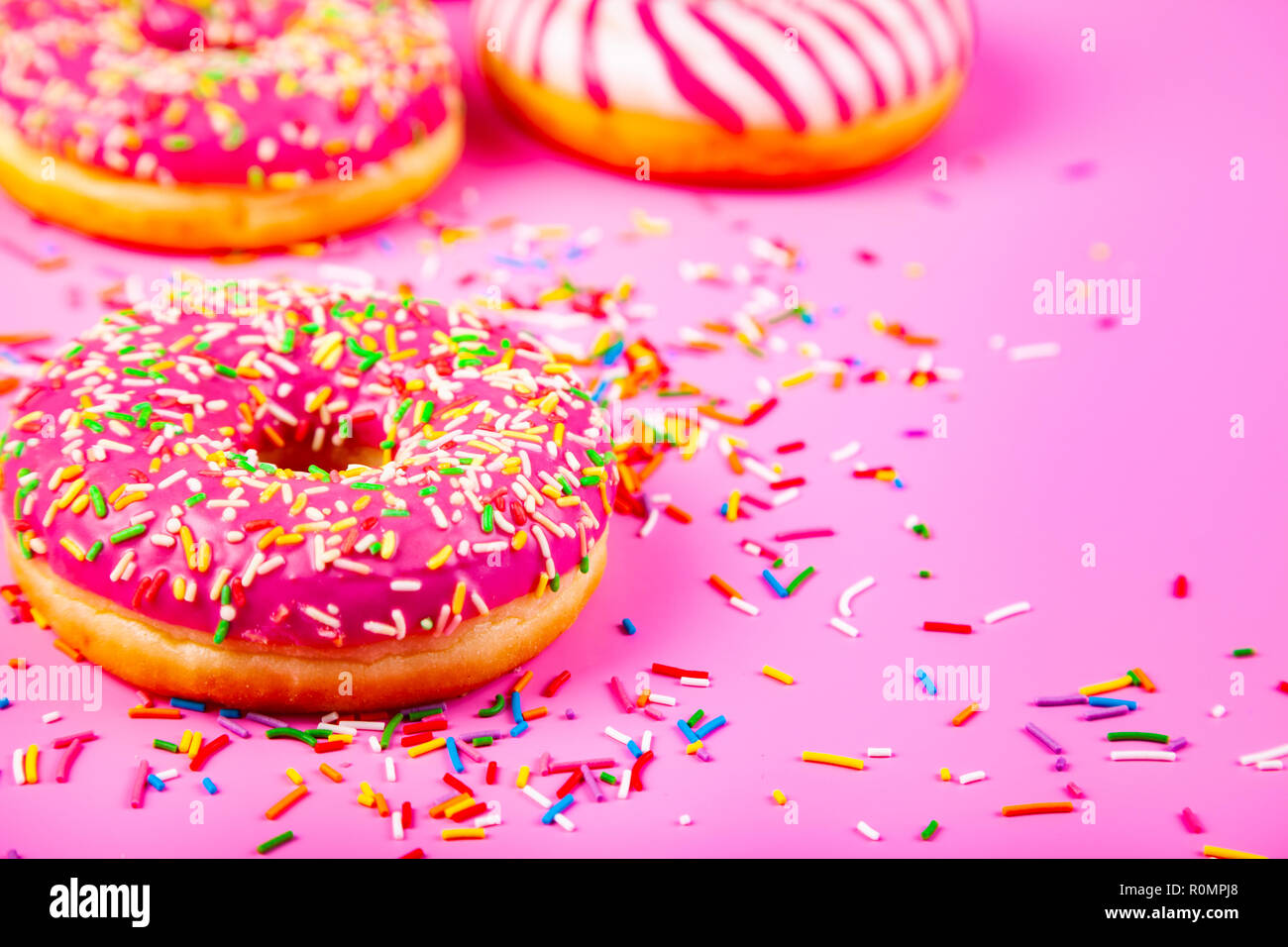 Donuts on a pink background. Delicious dessert. Stock Photo