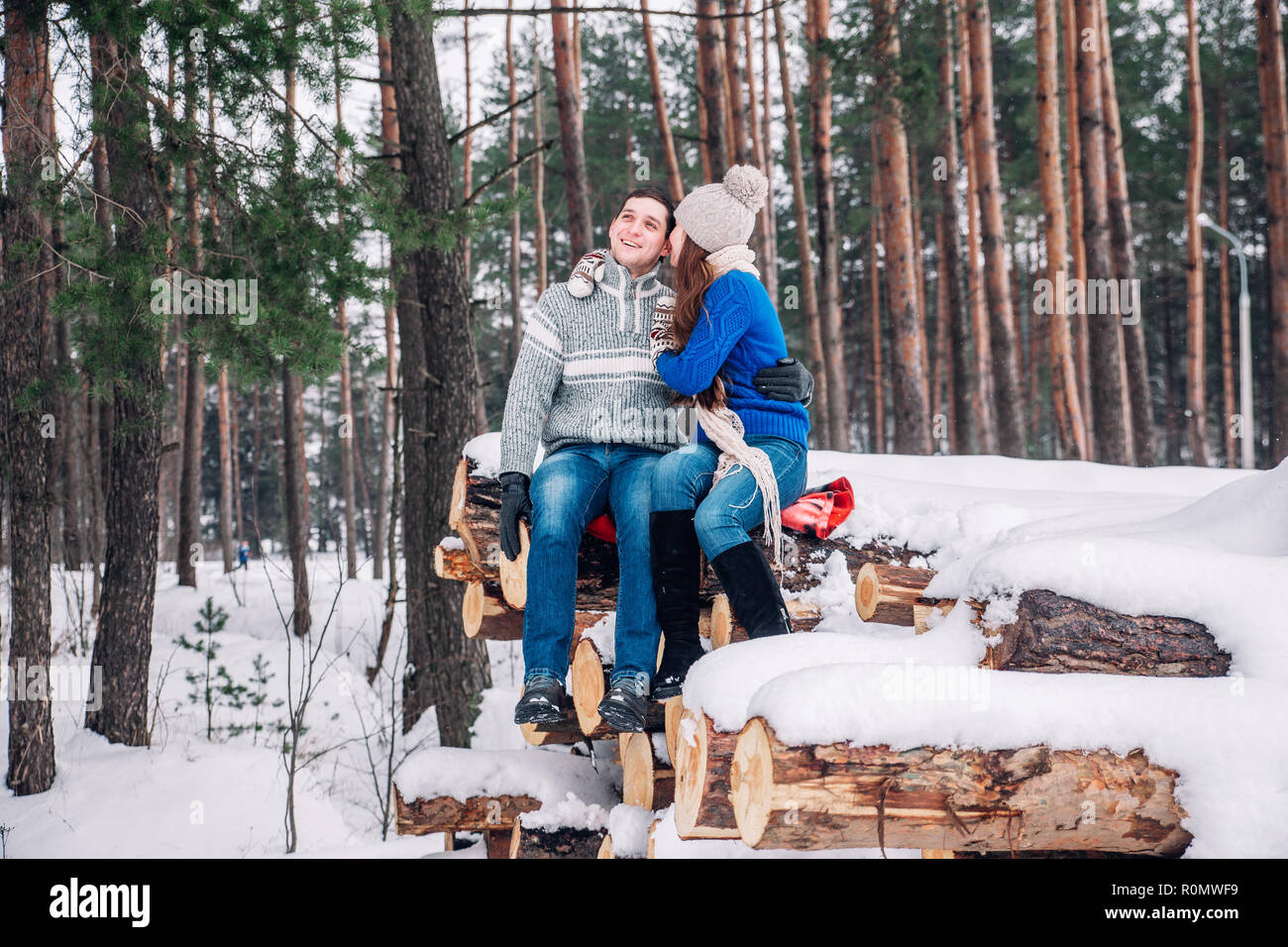 christmas happy couple in love embrace in snowy winter cold forest ...