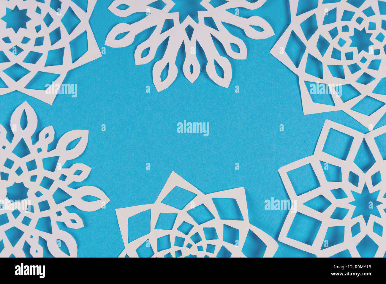 Paper snowflakes frame on blue background. Top view. Christmas ...