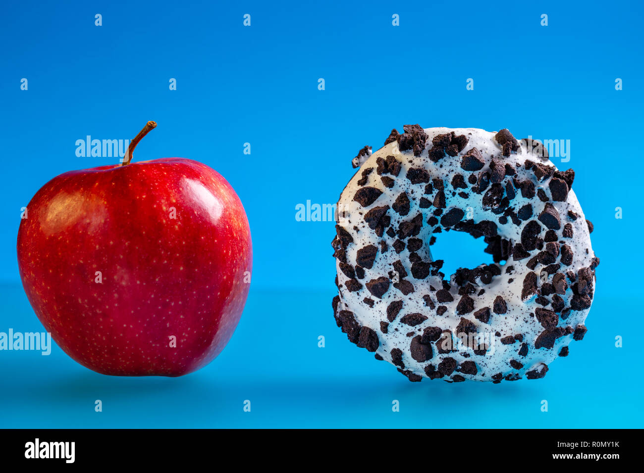 Apple and donut, concept of choice health and unhealthy diet. Stock Photo