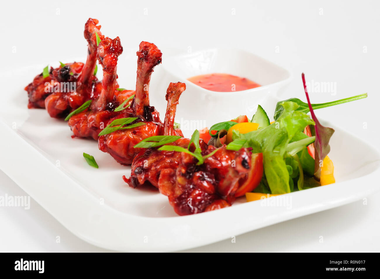 fried chicken wings in pomegranate sauce Stock Photo