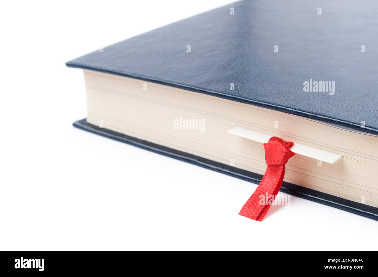 Close-up of a book with bookmark, on white background. Selective focus and shallow depth of field. Stock Photo