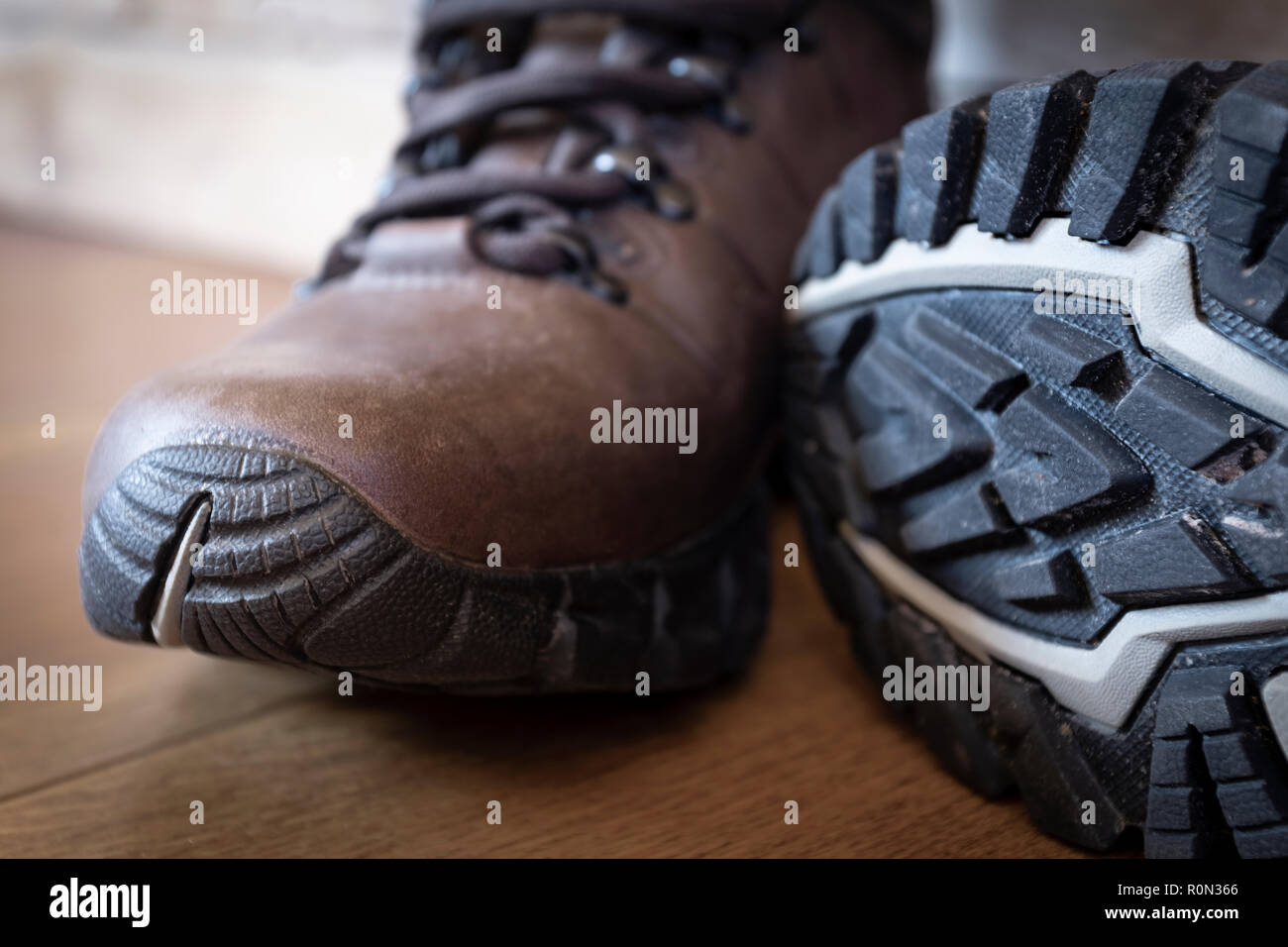 Deep tread lugs on the soles of a new pair of walking boots. Stock Photo