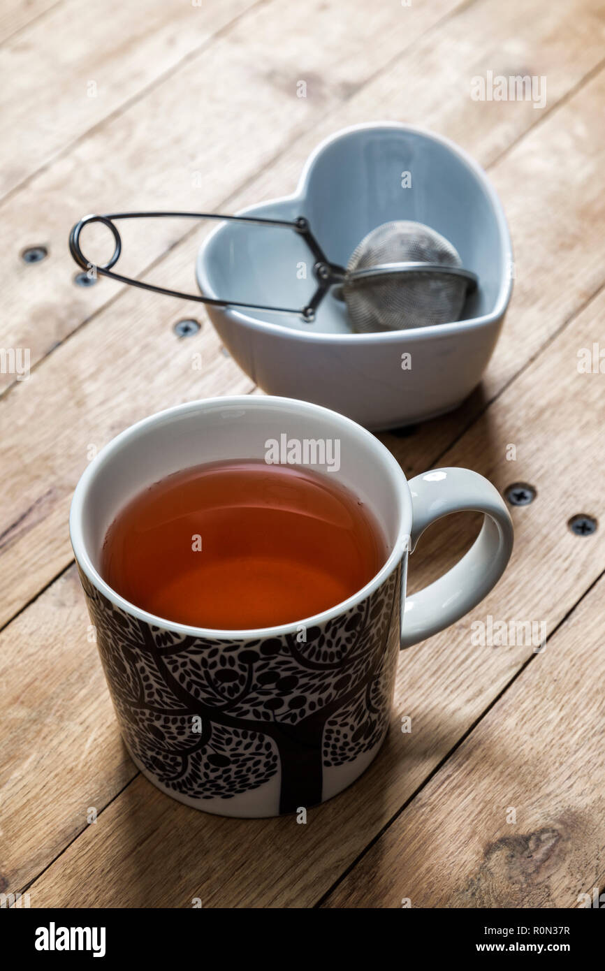 A mug of herbal tea on a wooden table. Stock Photo