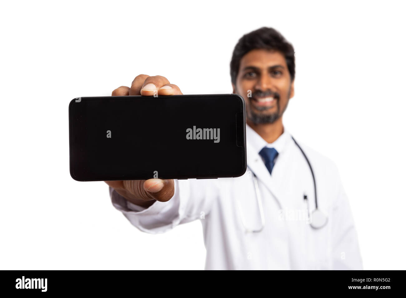 Indian Smiling Male Medic Presenting Phone With Horizontal Copyspace 