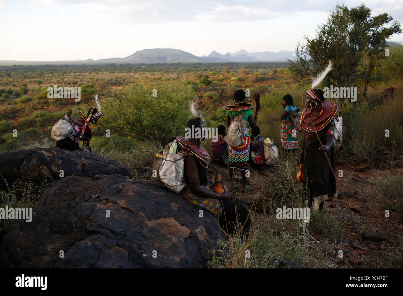Women take a rest on a hilltop after walking for several kilometres in Baringo County, Kenya, October 1, 2018. Stock Photo