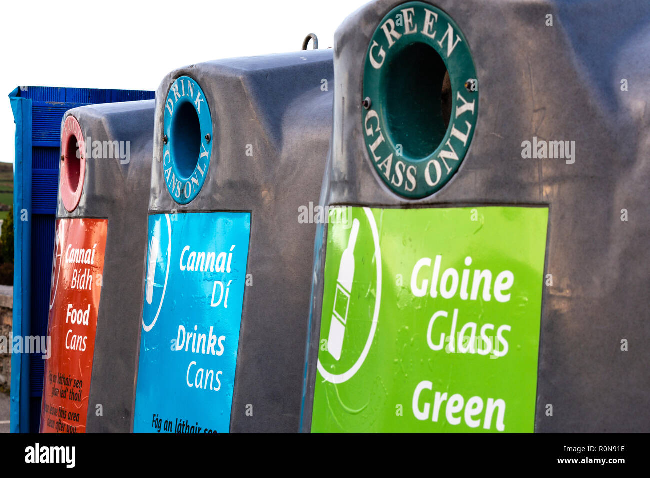 Glass recycling bins for various colours with Irish writing Stock Photo