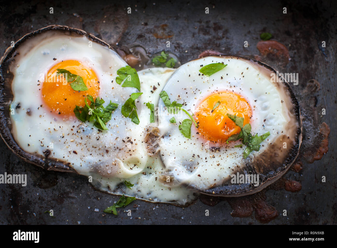 Brunch of baked eggs on portobello mushrooms Stock Photo