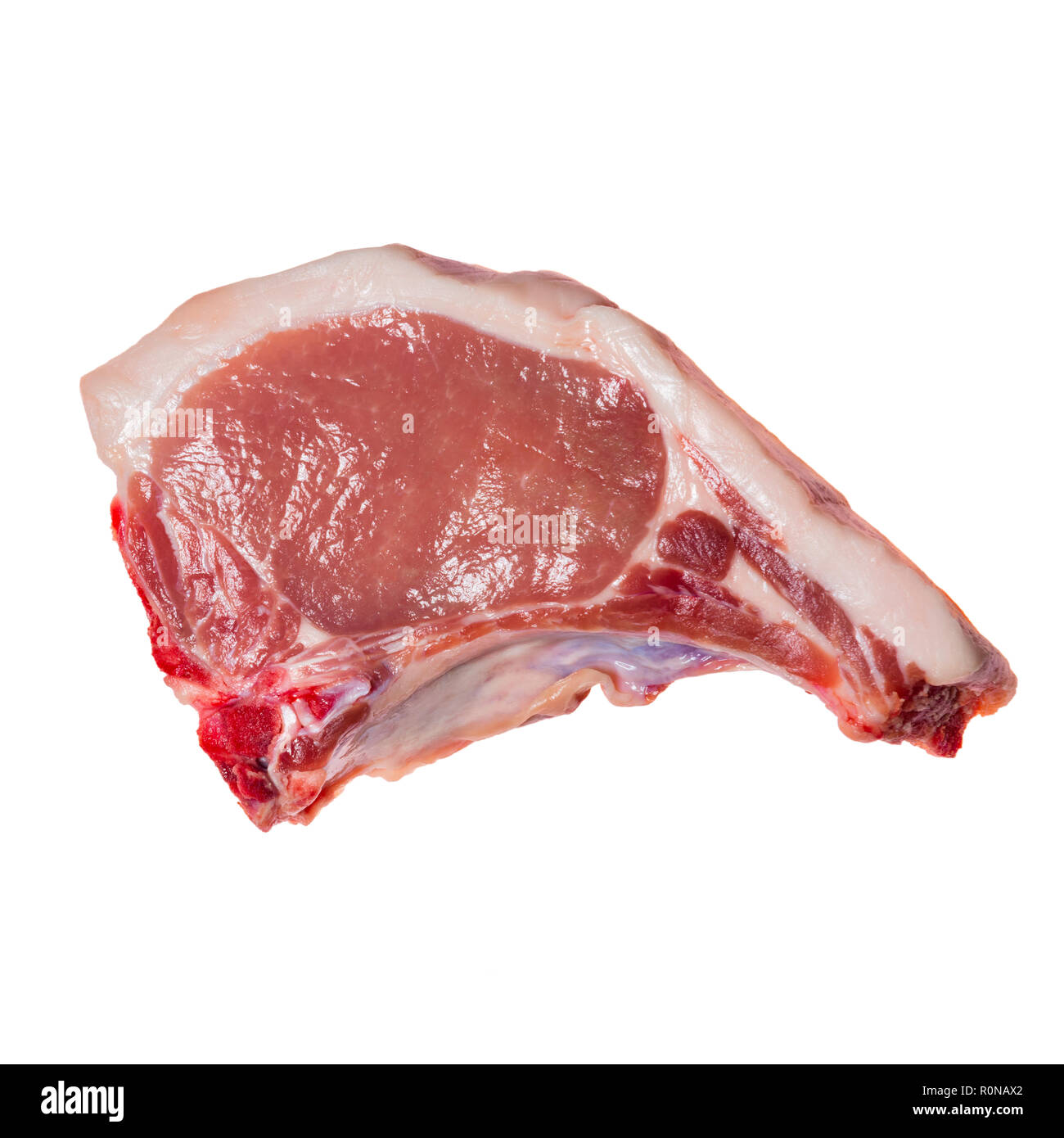 Traditional pork chop from a farm shop butcher, UK. Uncooked meat chop from above on a white background. Stock Photo