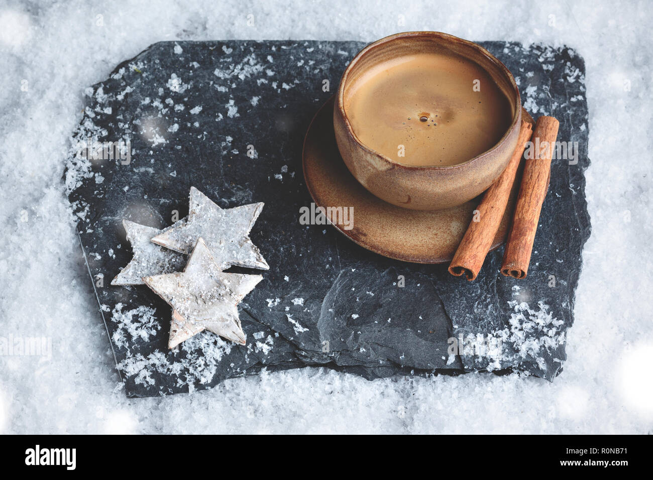 Stylish espresso cup with winter decoration on snow Stock Photo