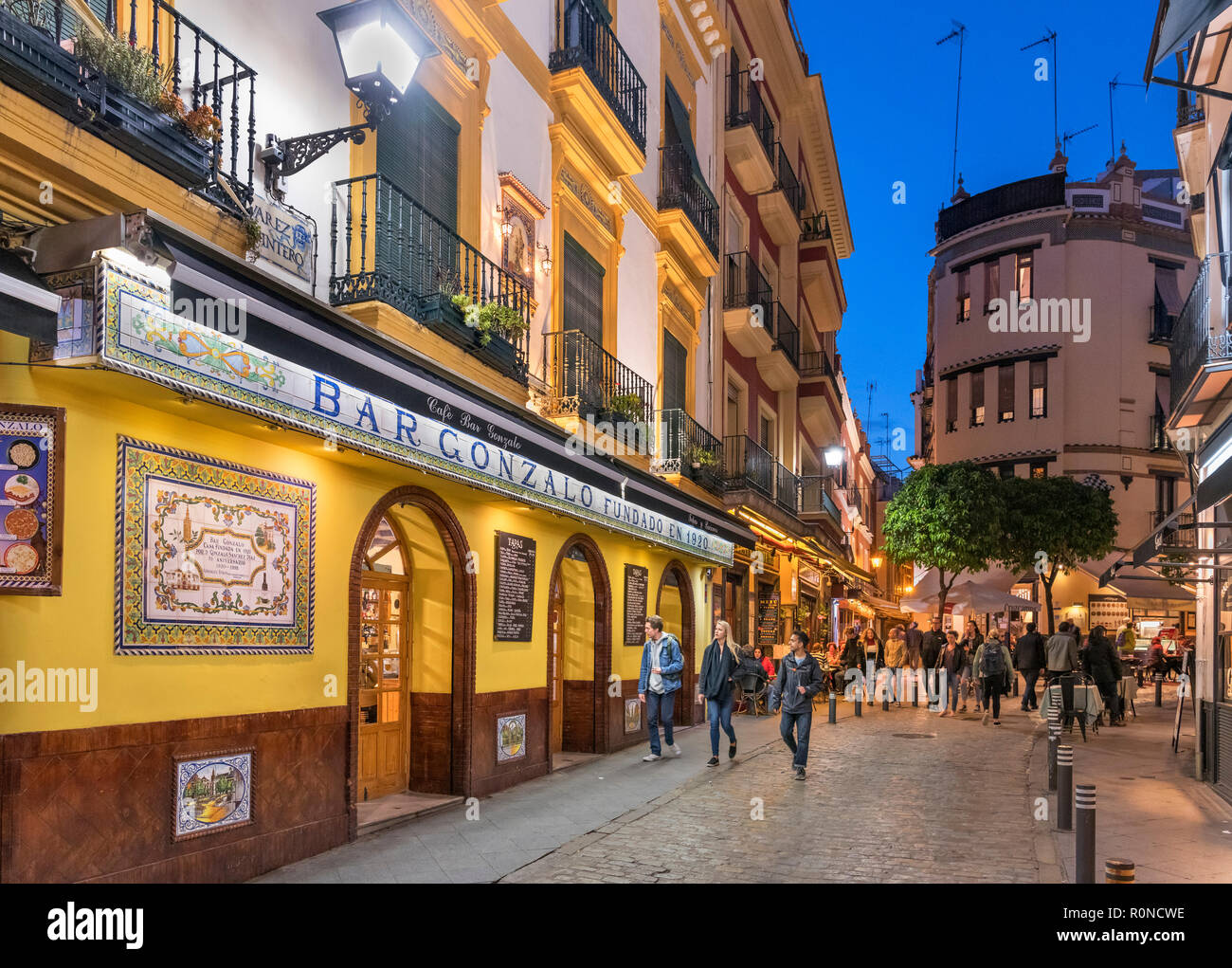 Bars, cafes and restaurants at night, Calle Conteros, Barrio Santa Cruz, Seville, Andalucia, Spain Stock Photo