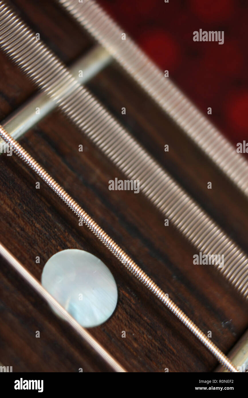 Acoustic guitar fretboard with steel strings vibrating, closeup Stock