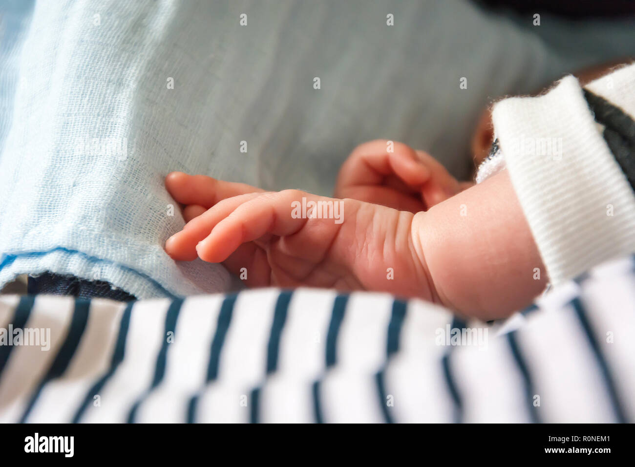 hand of a newborn child while sleeping peacefully Stock Photo