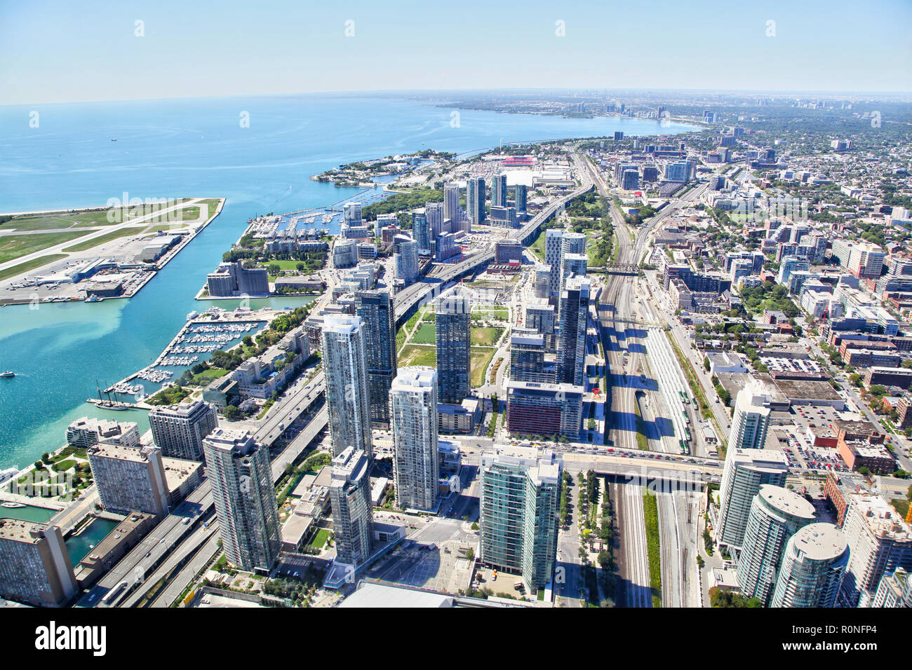 Aerial view of the Toronto's harbourfront cityscape with freeways and Billy Bishop Airport on Toronto Islands on Lake Ontario. Stock Photo