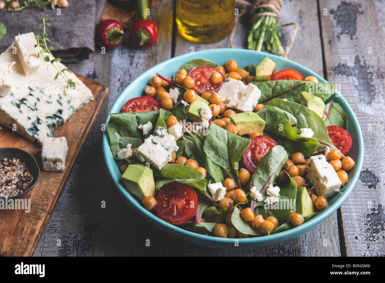 Healthy vegan salad with avocado ,beet leaves ,chickpea, broccoli ,tomato,blue cheese Stock Photo