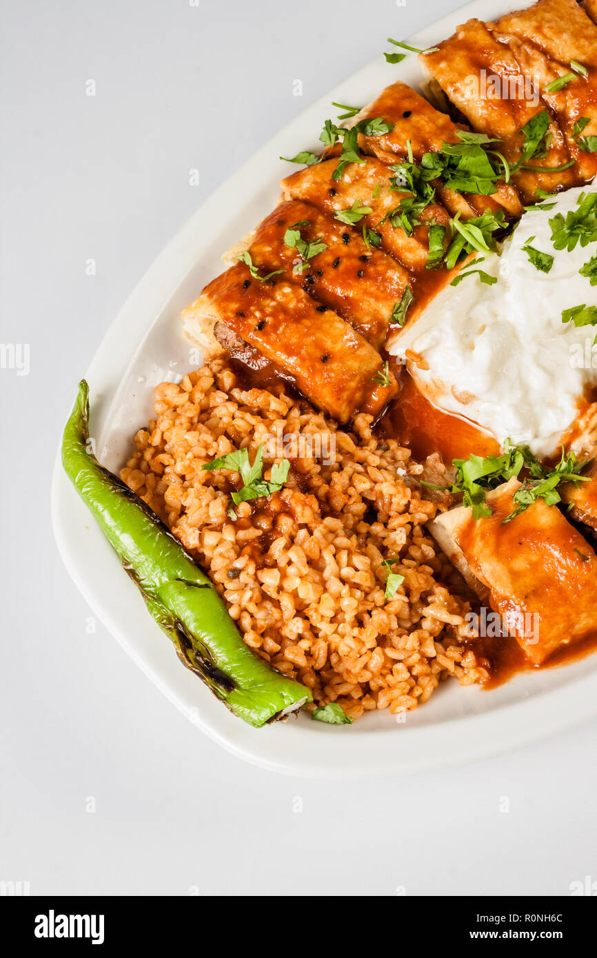 Turkish Beyti Kebab served with bulgur pilaf and yoghurt Stock Photo