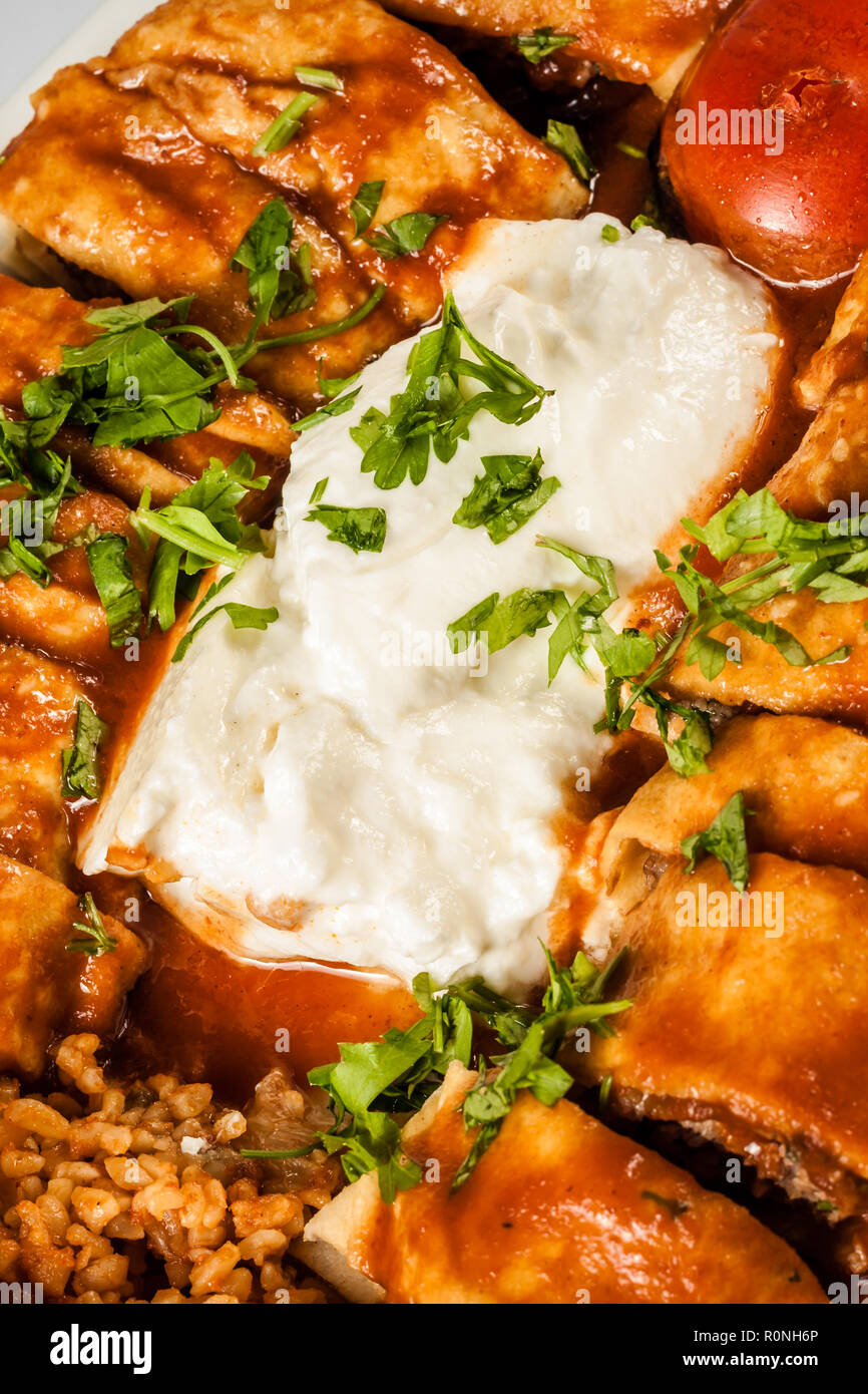 Turkish Beyti Kebab served with bulgur pilaf and yoghurt Stock Photo
