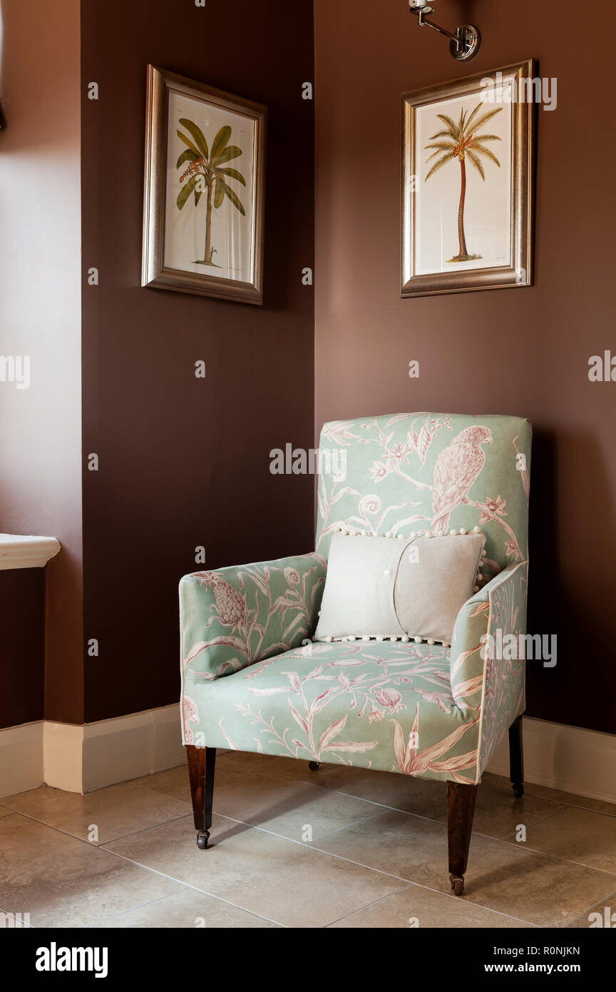 Patterned armchair by palm tree paintings in Carlton Tower in Yorkshire Stock Photo