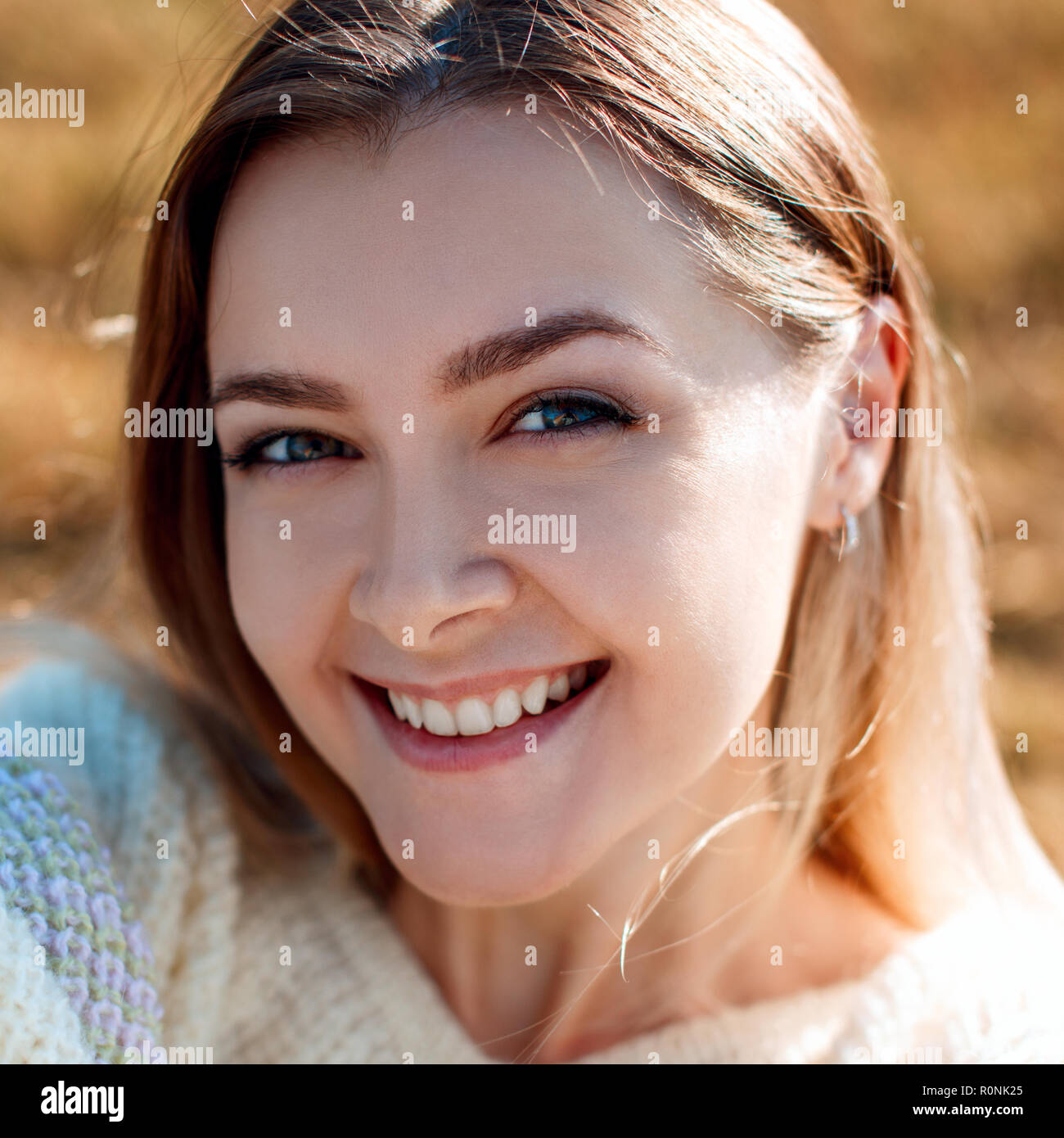 Smiling young woman makes selfie and enjoying nature in autumn season. Stock Photo