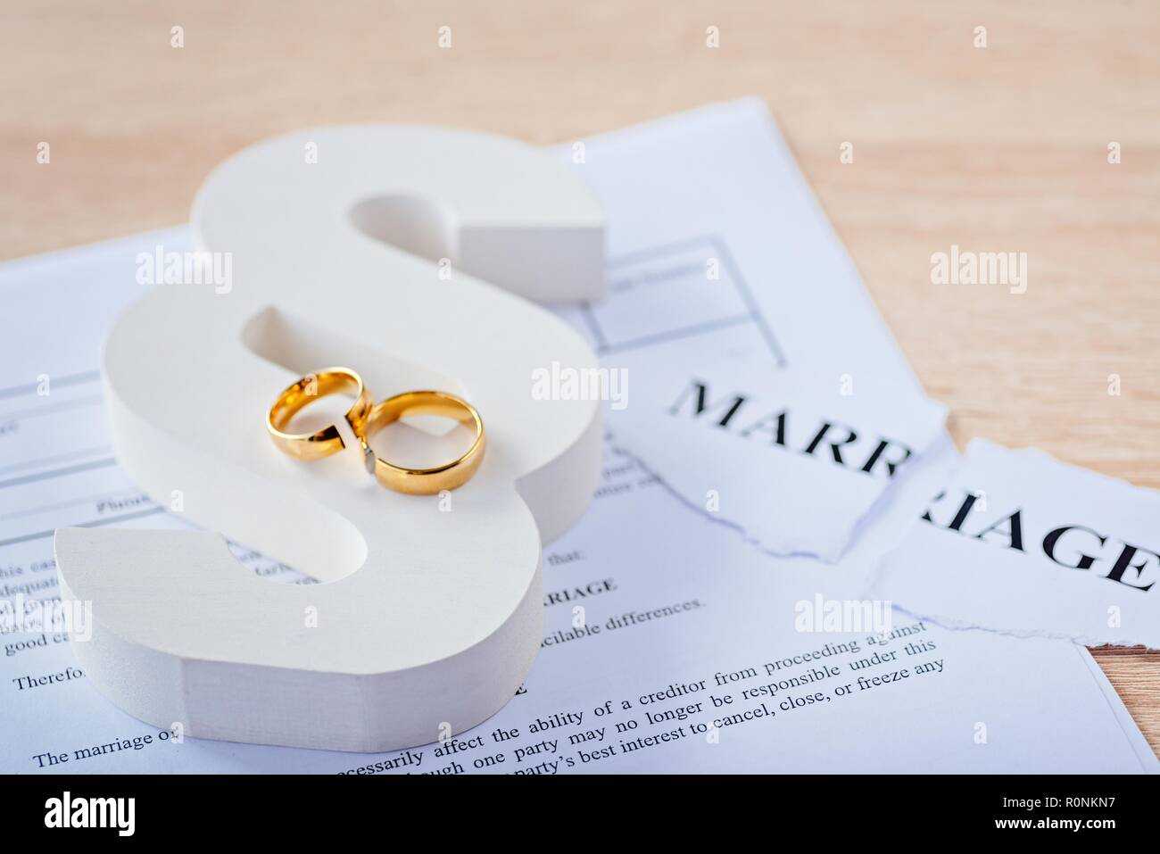 Two Broken Rings Two broken wedding rings on wooden paragraph. Divorce, separation and ...