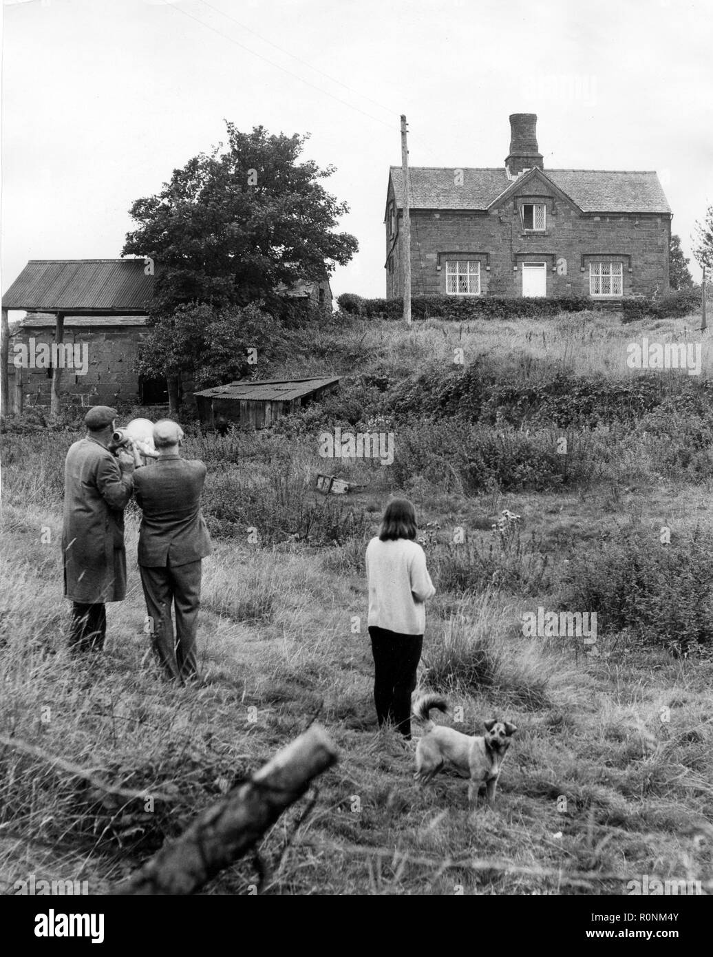 The scene of the longest siege in Britain as friends and relatives of John James try to pursuade him to leave the derelict cottage in Weston under Redcastle in Shropshire 1968 Stock Photo