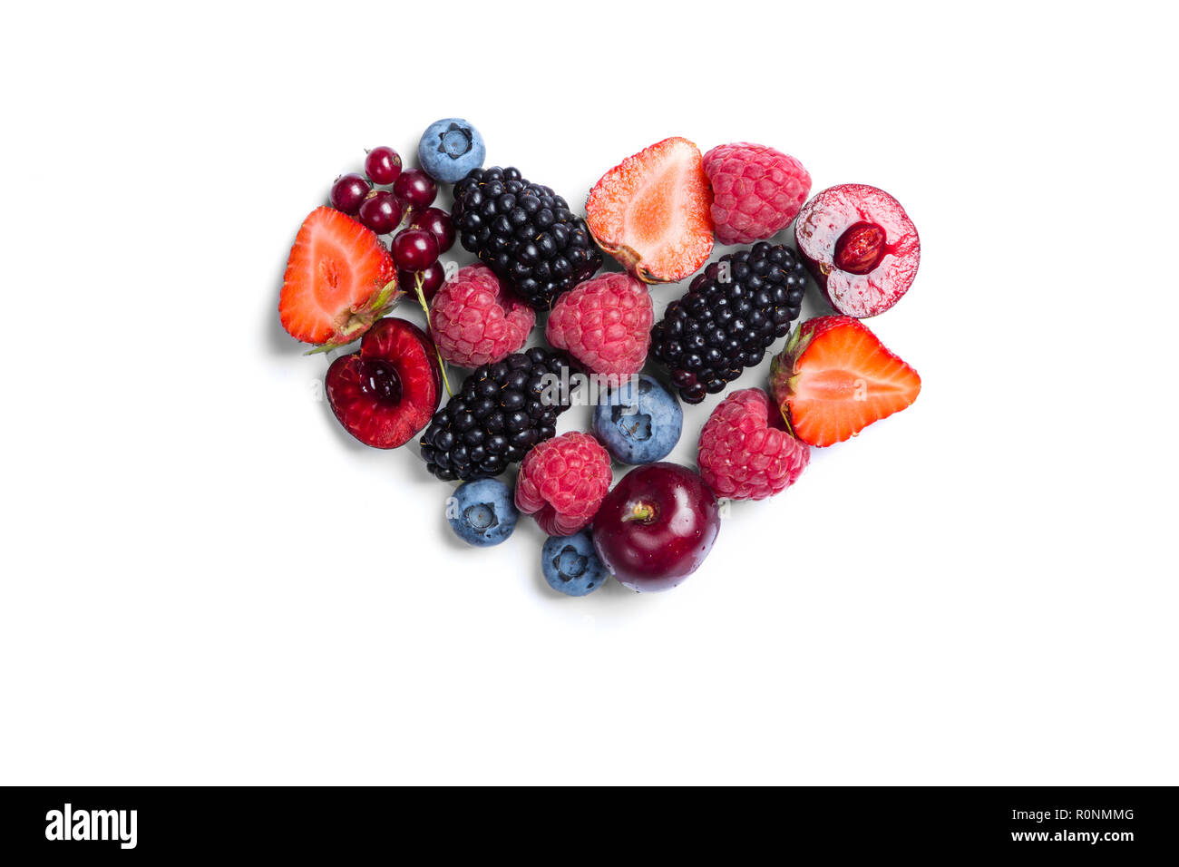 Heart shaped raspberries on white background Stock Photo - Alamy