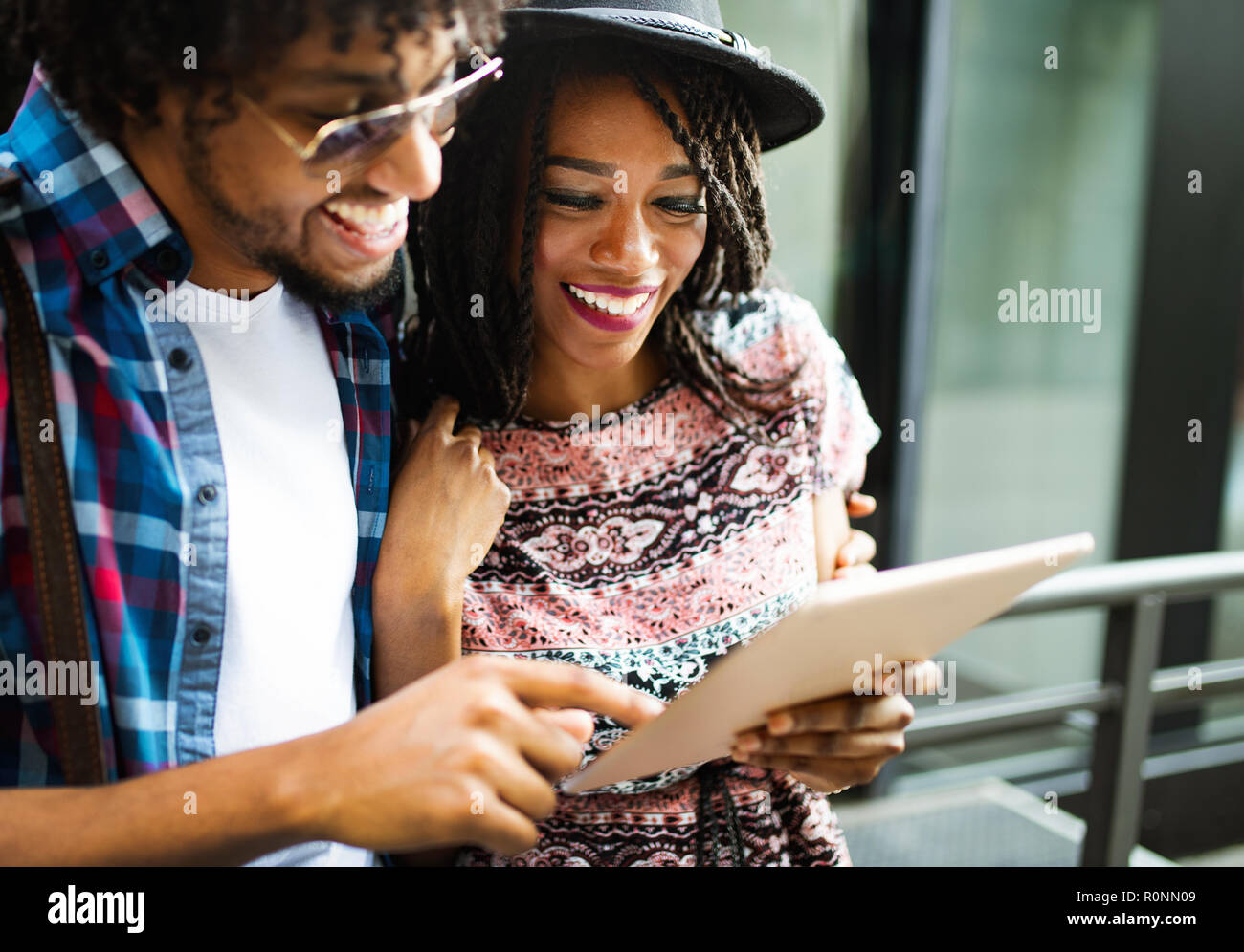 Close up portrait of happy young black couple using a digital tablet ...