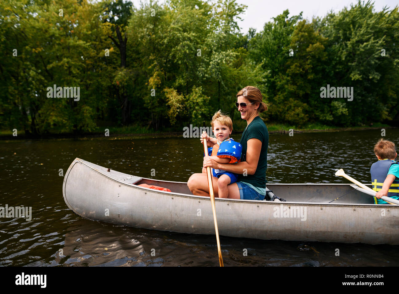 Mother canoeing with her two sons, United States Stock Photo