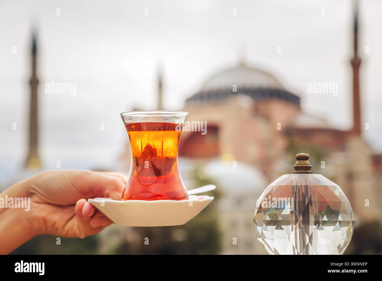 Cup of Turkish tea against the background of the Hagia Sophia Museum. Istanbul, Turkey. Stock Photo