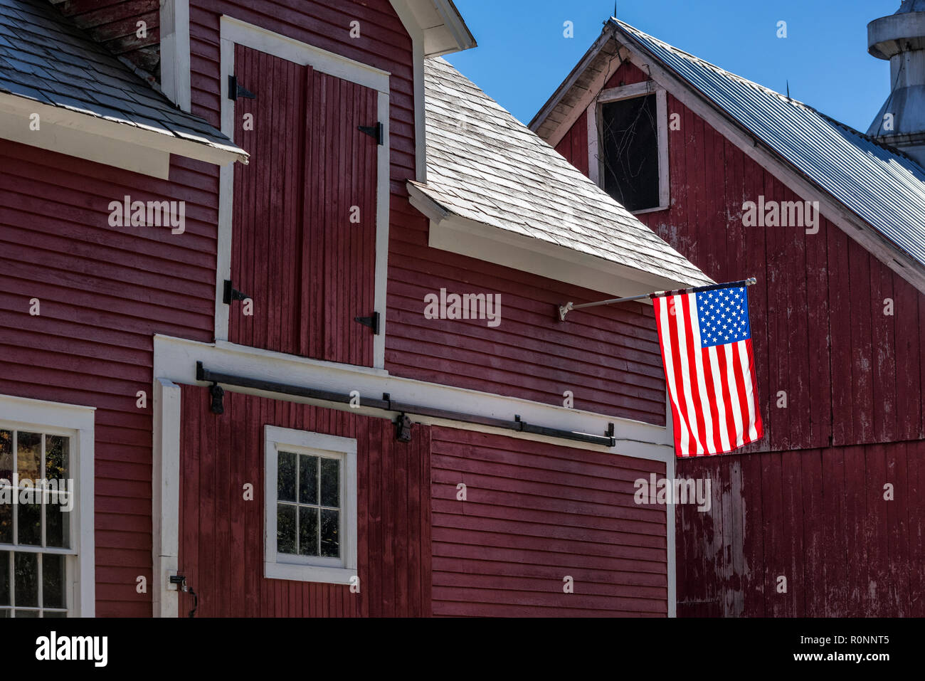 American flag on rustic red barn.Colrain, Massachusetts, USA. Stock Photo