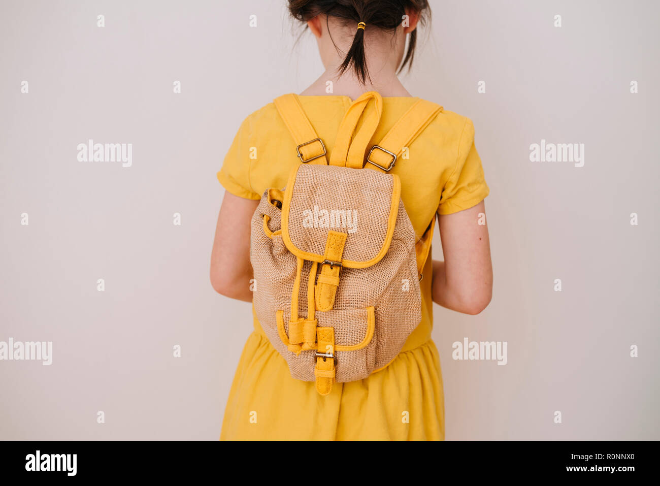 Rear view of a girl wearing a backpack Stock Photo