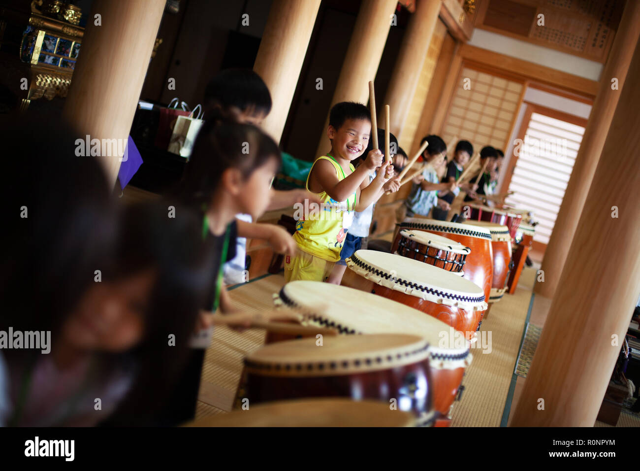 Group of children playing the drums in a temple, a traditional set of drums. Stock Photo