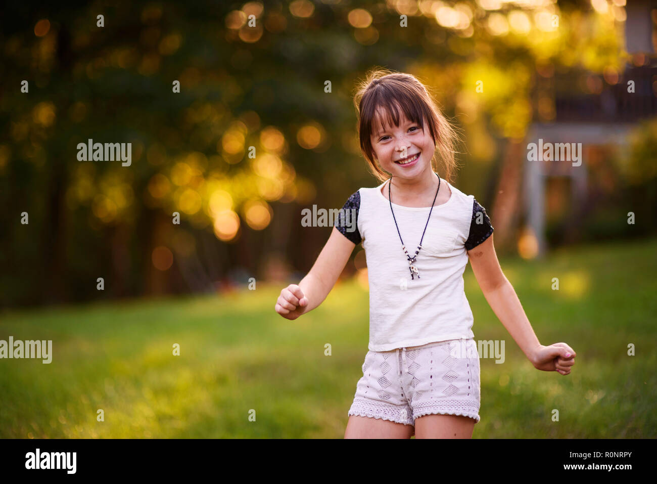 Portrait of a smiling girl dancing in the park Stock Photo