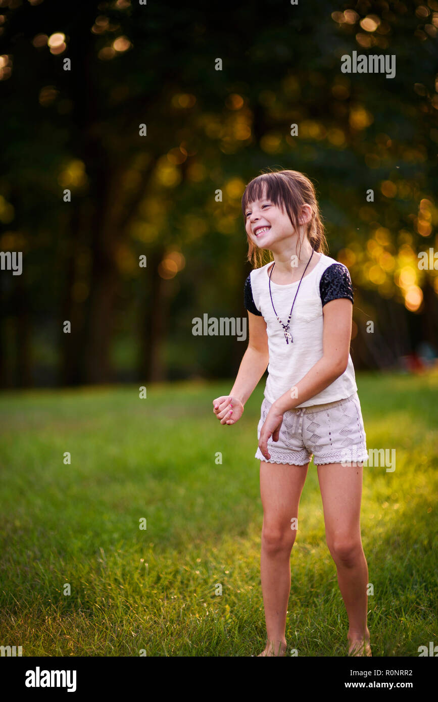 Portrait of a smiling girl dancing in the park Stock Photo