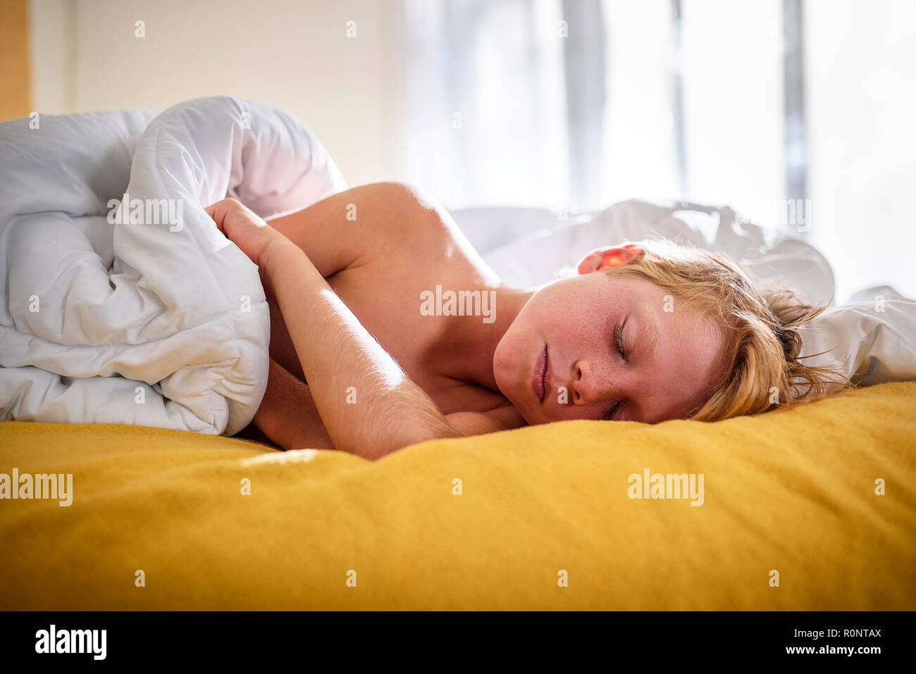 Boy sleeping in bed Stock Photo