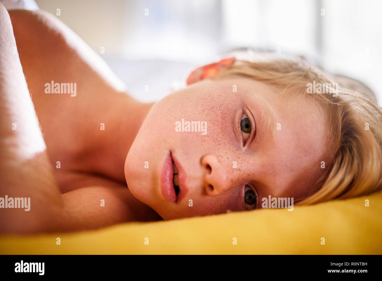 Portrait of a boy in bed waking up Stock Photo