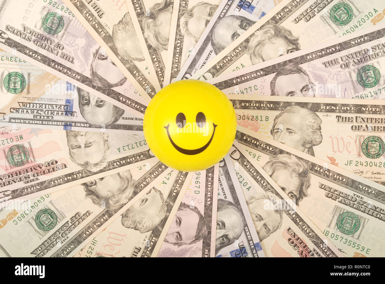 Yellow smile faces on mandala kaleidoscope from money. Abstract money background raster pattern repeat mandala circle. Stock Photo